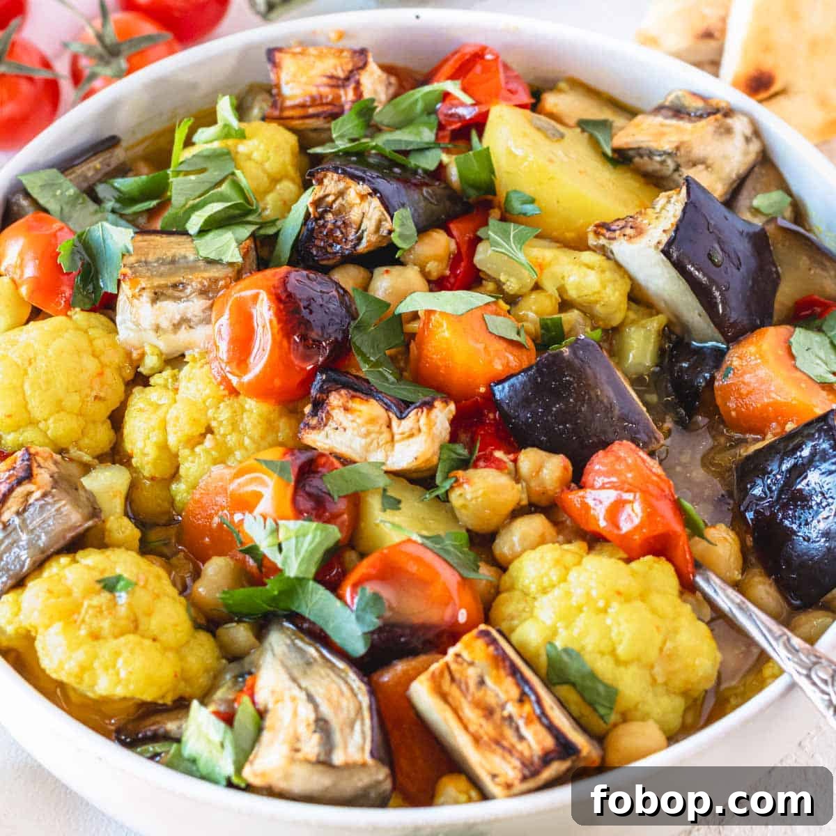 30 Delicious Eggplant Recipes for Every Meal 16 Vegetable stew with a silver spoon in a white bowl