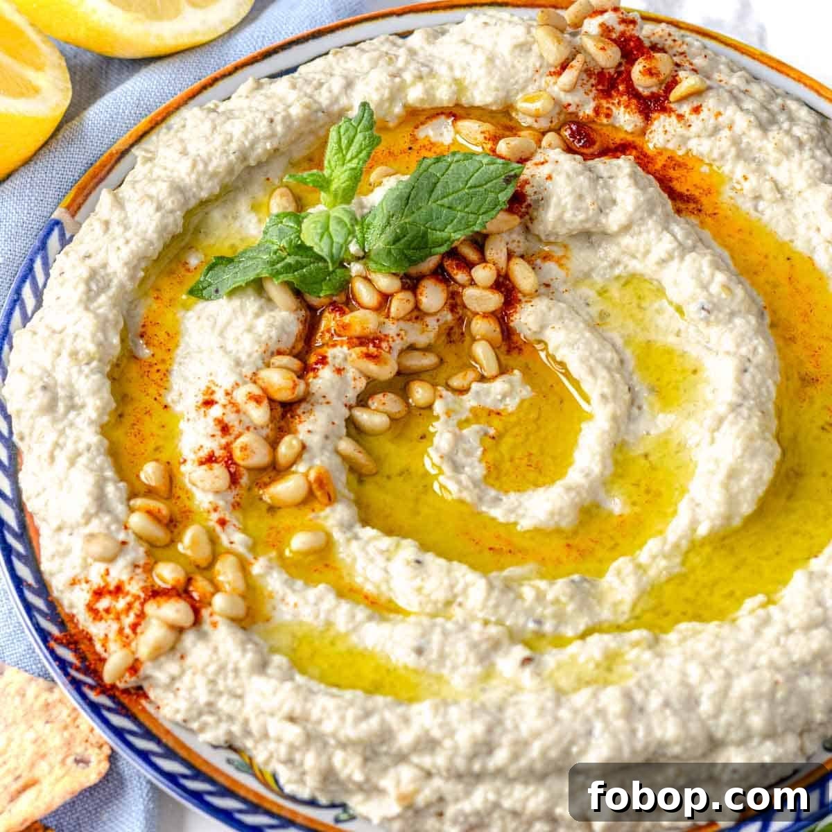 30 Delicious Eggplant Recipes for Every Meal 21 Mutabal on a plate with fresh mint and toasted pine nuts
