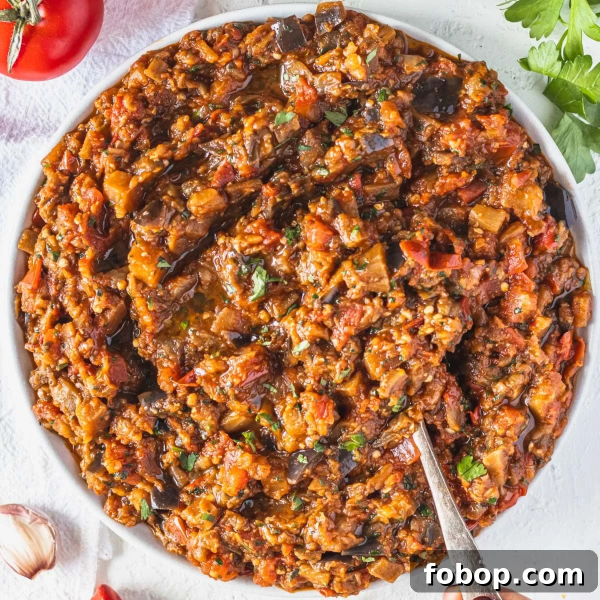 30 Delicious Eggplant Recipes for Every Meal 22 Zaalouk in a bowl with a silver spoon