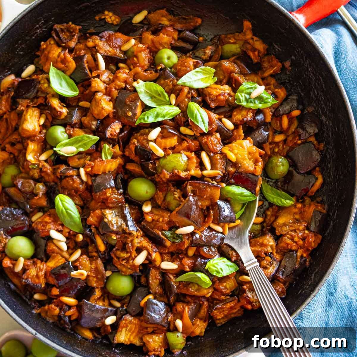 30 Delicious Eggplant Recipes for Every Meal 23 Authentic Sicilian caponata recipe styled in a skillet with a spoon, perfect as a Mediterranean side or plant-based appetizer.