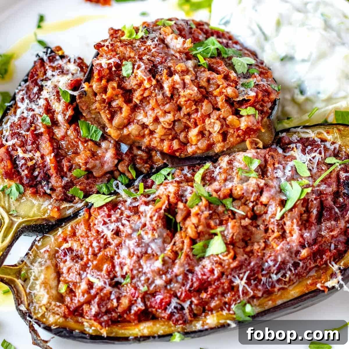 30 Delicious Eggplant Recipes for Every Meal 4 Stuffed eggplant cut into half with parmesan cheese and parsley