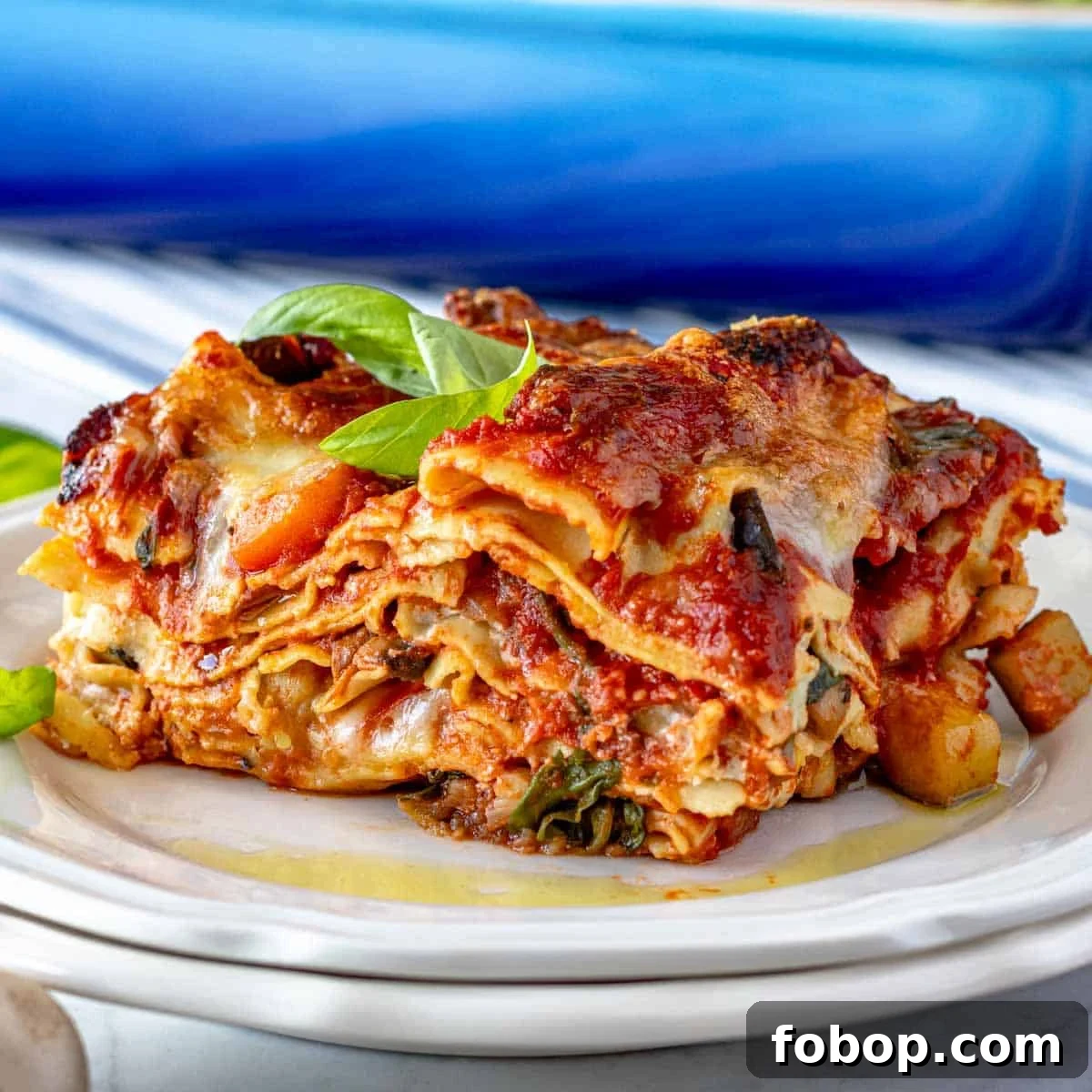 30 Delicious Eggplant Recipes for Every Meal 5 vegetable lasagna with diced vegetables and basil on a plate