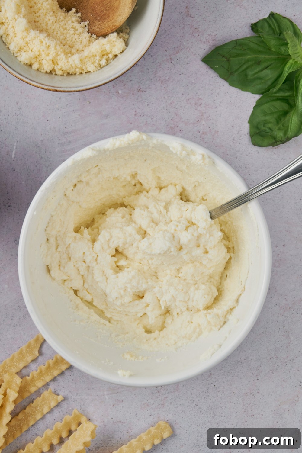 A bowl with ricotta cheese mixture.