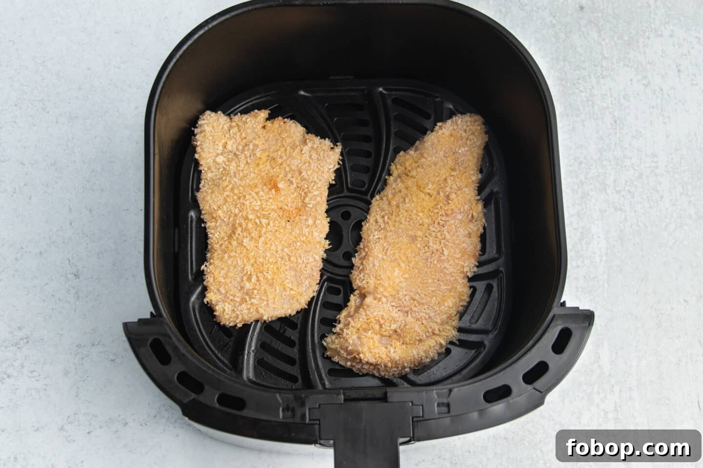 This is a picture of a chicken cutlets in the air fryer.