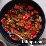 homemade peanut butter granola in a bowl with dried strawberries.