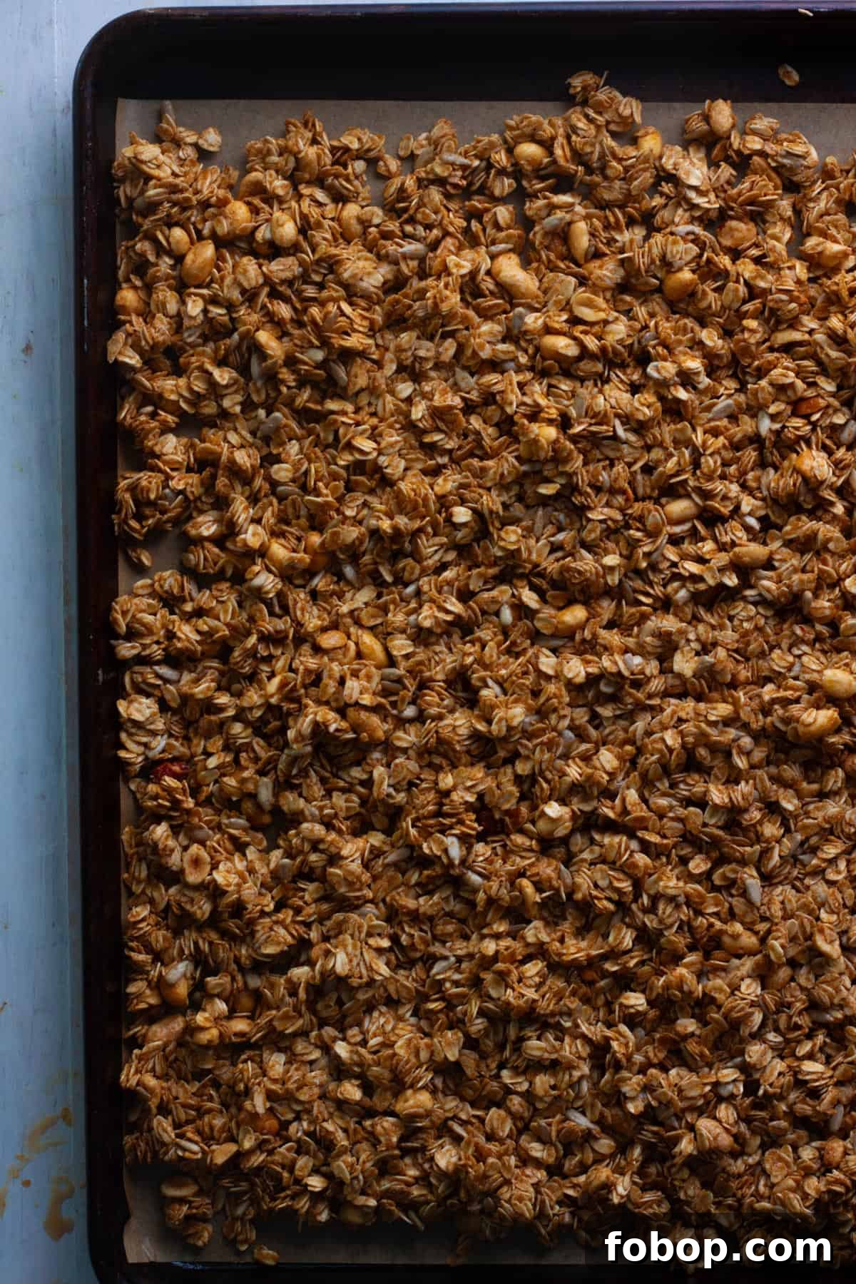 Crunchy Peanut Butter Granola Recipe for Homemade Snacks 6 Homemade peanut butter granola on a sheet tray getting ready to get baked.