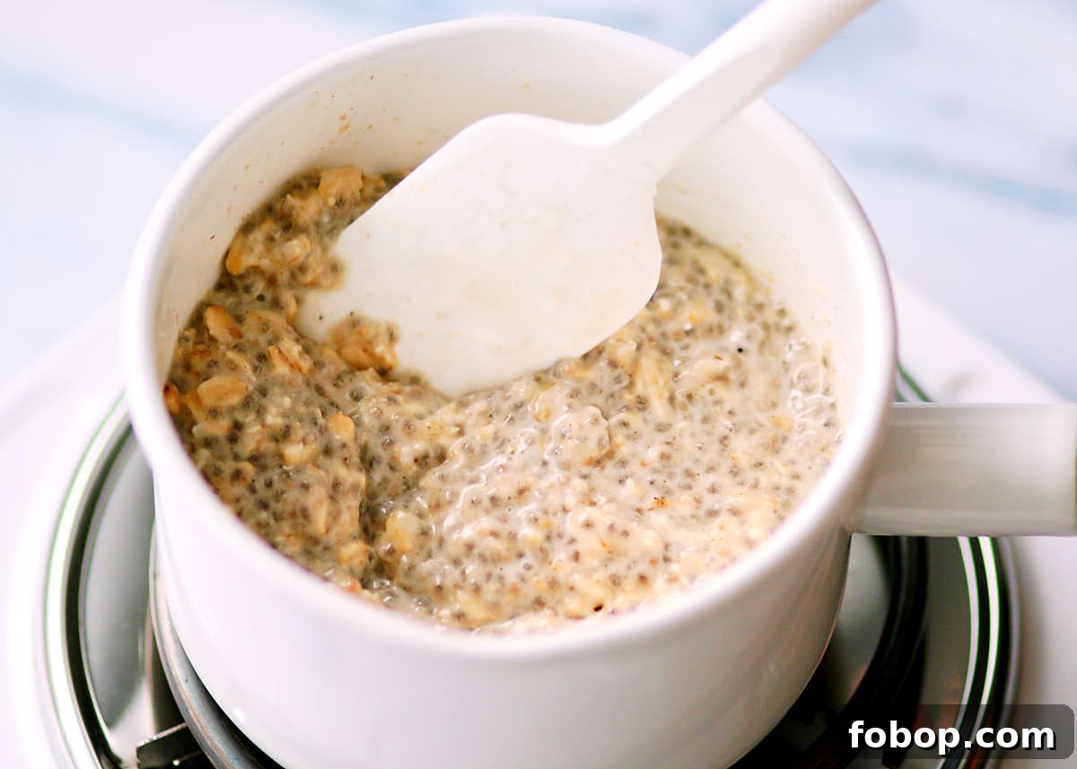 Warming up overnight oats with coconut milk in a saucepan.