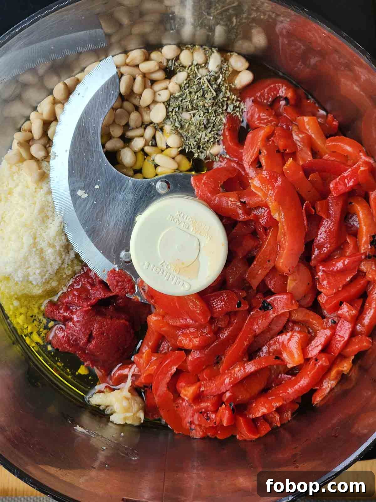 Smoky Roasted Red Pepper Pesto Recipe for Pasta & Sandwiches 4 Ingredients for roasted red pepper pesto in a food processor.