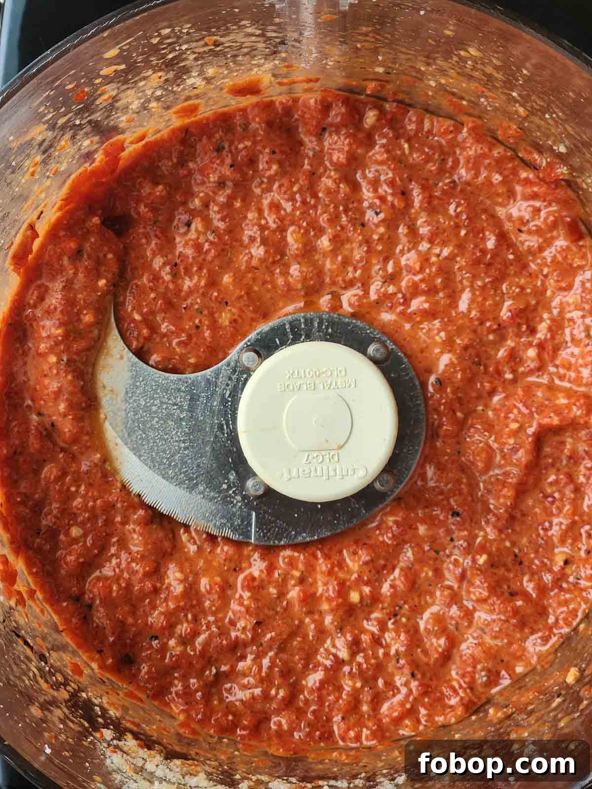 Smoky Roasted Red Pepper Pesto Recipe for Pasta & Sandwiches 5 Overhead picture of red pepper pesto in a food processor.