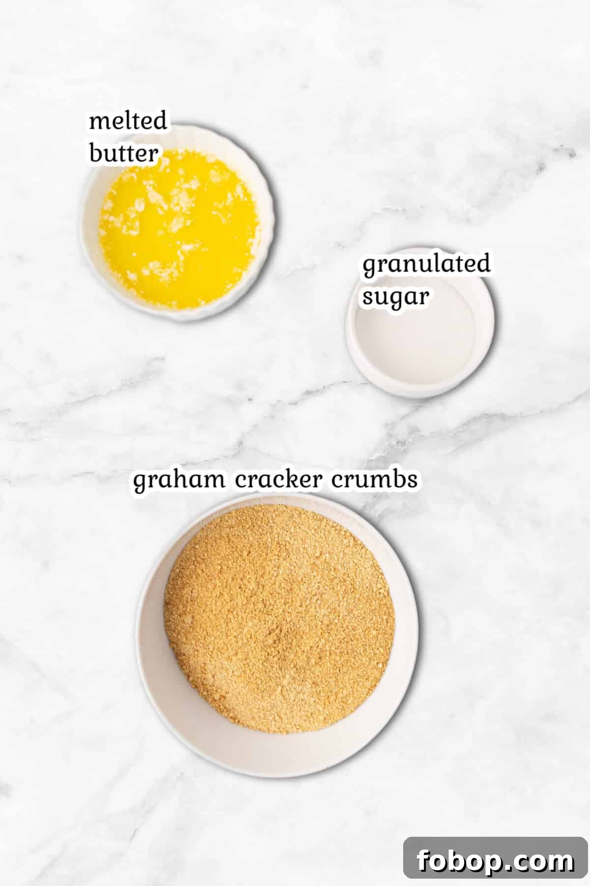 Perfect Graham Cracker Crust Recipe for Pies and Cheesecakes 2 Ingredients for the graham crackers crust on a marble surface.