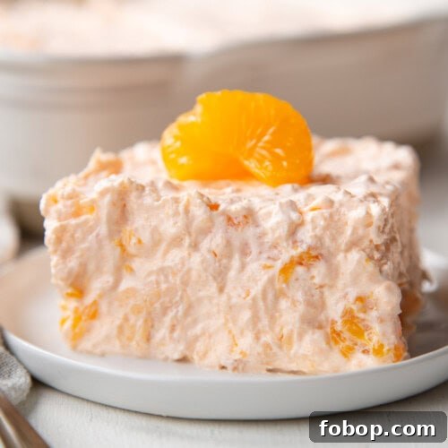 slice of a fluffy gelatin salad with mandarin oranges