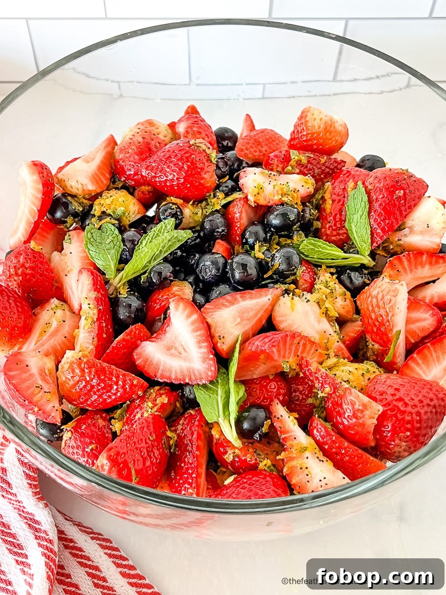 Fresh Blueberry and Strawberry Summer Salad Recipe 7 Glass bowl filled with strawberry blueberry salad.