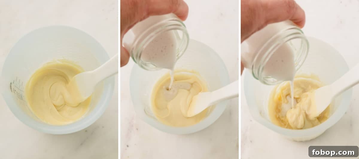 Coconut milk being poured into melted white chocolate.