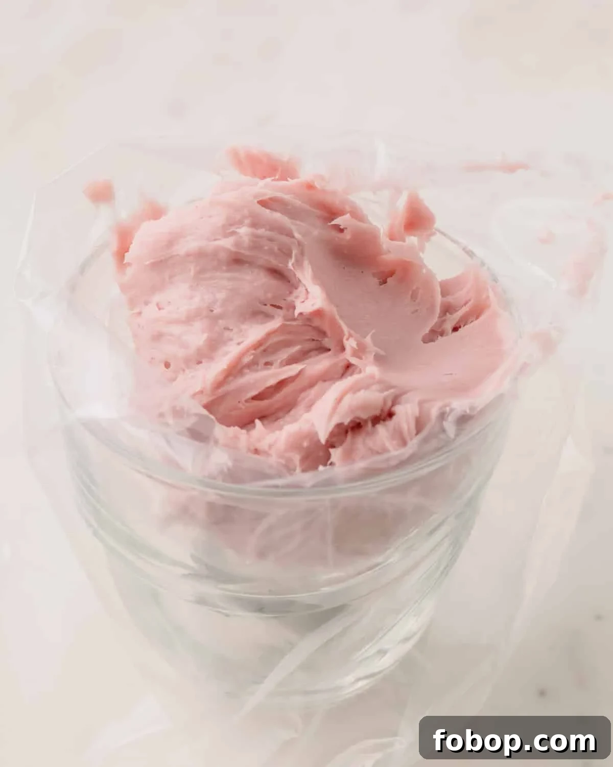 Dairy-free strawberry ganache in a piping bag.