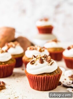sweet potato cupcake topped with marshmallow frosting and chopped pecans
