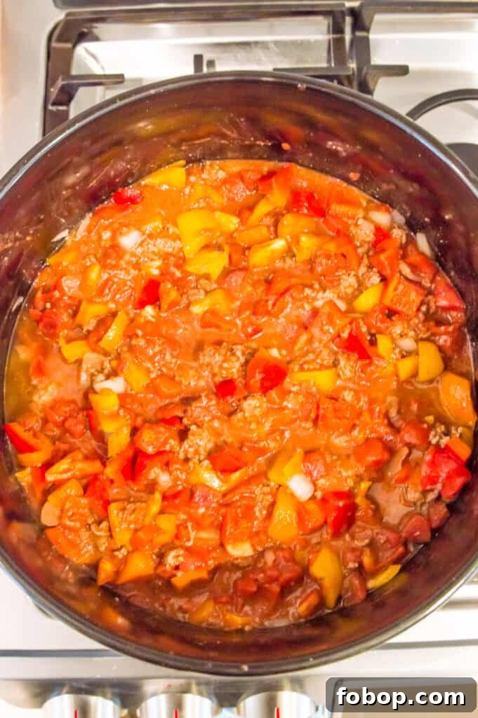 Ground Pork Chili Recipe Without Beans — Hearty Skillet Chili 8 A pot on the stovetop with chili in it.