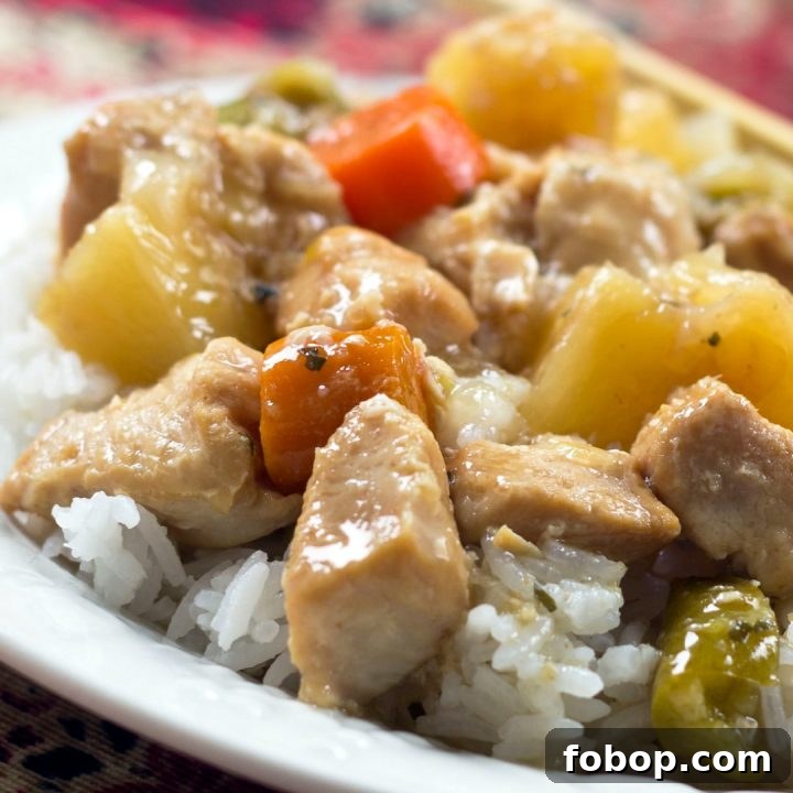 Slow Cooker Sweet and Sour Chicken Recipe Chunks of cooked chicken, pineapple, carrots, and peppers served over white rice
