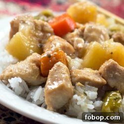 Slow Cooker Sweet and Sour Chicken Recipe for Tender, Saucy Results 2 Chunks of cooked chicken, pineapple, carrots, and peppers served over white rice