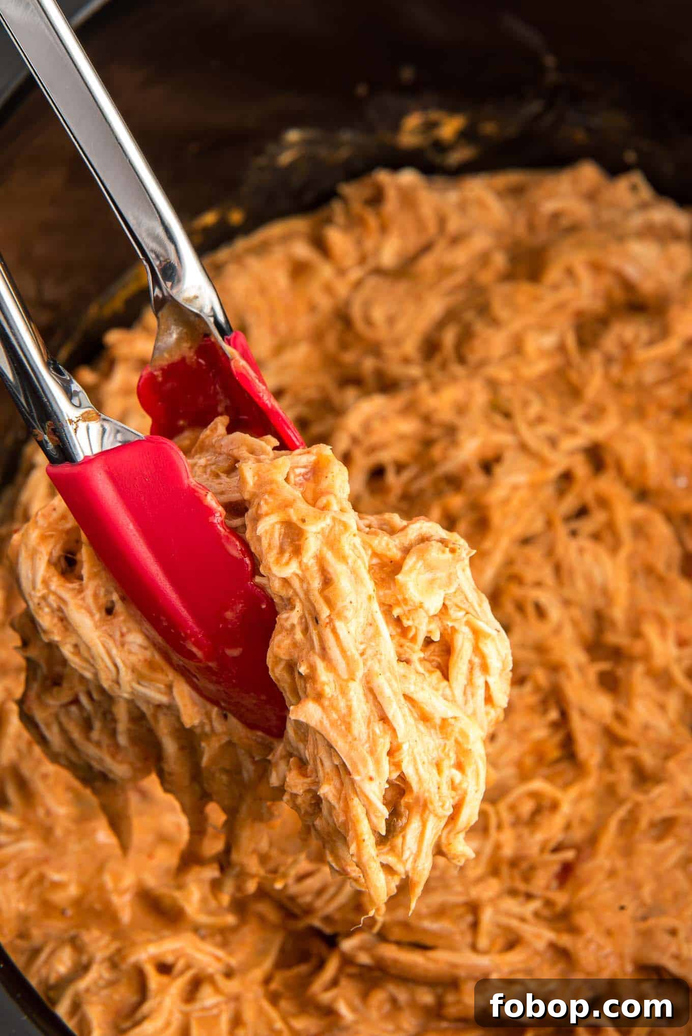Shredded crockpot salsa chicken in a crockpot ready to serve. 
