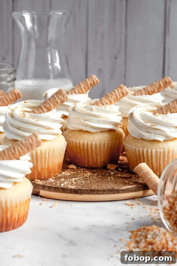 Cupcakes topped with whipped cream cheese frosting and toasted coconut