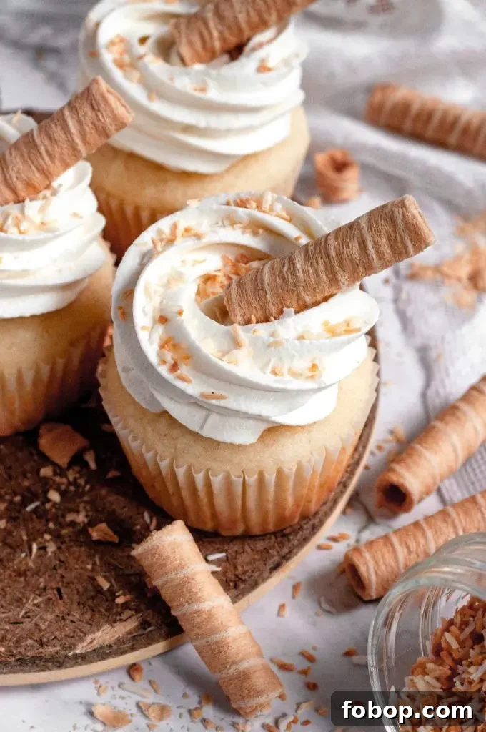 Coconut cupcakes with white frosting and toasted coconut