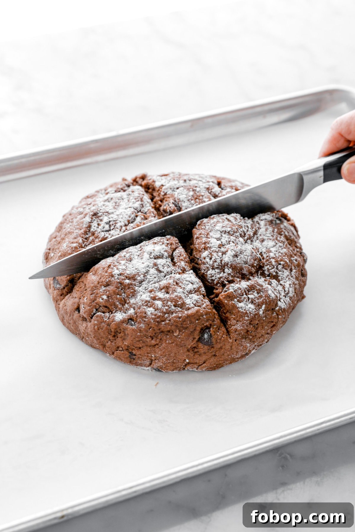 Double Chocolate Irish Stout Soda Bread Recipe for Rich Treat 9 knife inside chocolate dough on lined sheet pan.