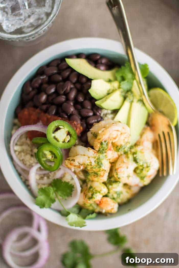 A loaded low carb burrito bowl, topped with cilantro lime marinated shrimp.