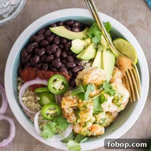 A top view of a low carb cilantro lime shrimp burrito bowl on cauliflower rice.