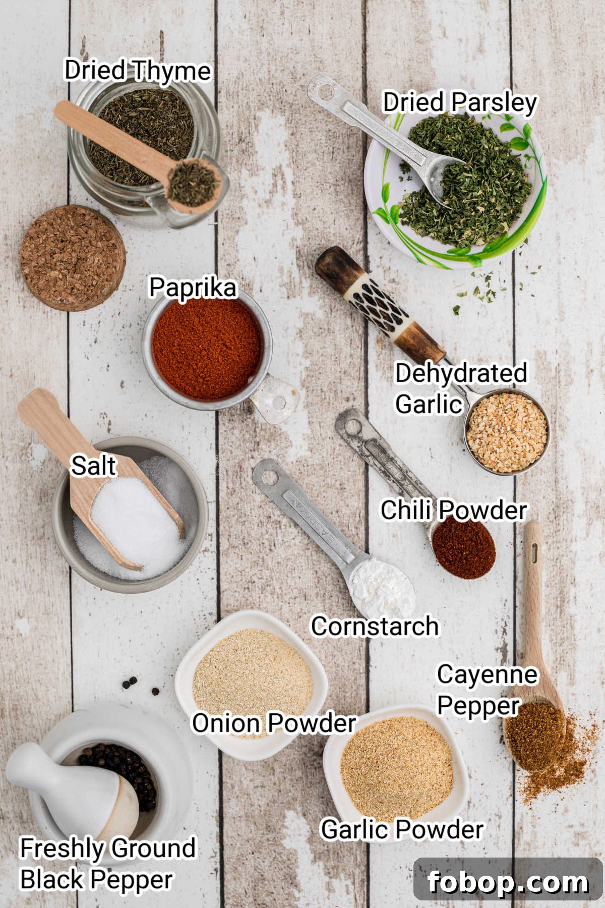 Authentic Homemade Creole Seasoning Recipe for Bold Flavor 3 spices and herbs all laid out with labels on them showing creole seasoning ingredients