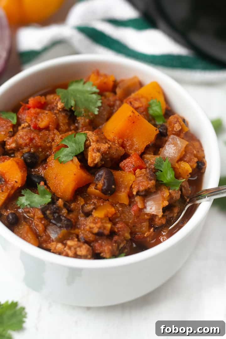 THE BEST Butternut Squash Turkey Chili A bowl of Butternut Squash Turkey Chili with cilantro