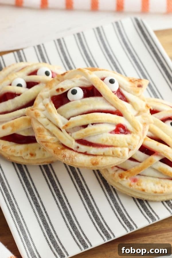 mummy hand pies on a plate stacked up 