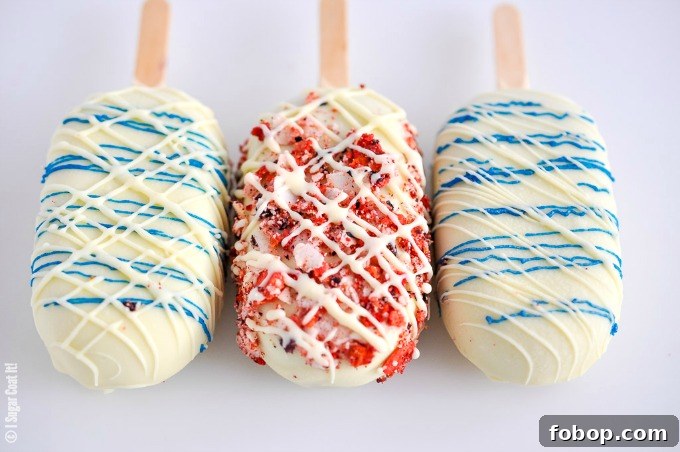 Blueberry Coconut Popsicles are a delightful blend of berries, coconut yogurt and milk dipped in decadent white chocolate and toasted coconut and freeze-dried berries.