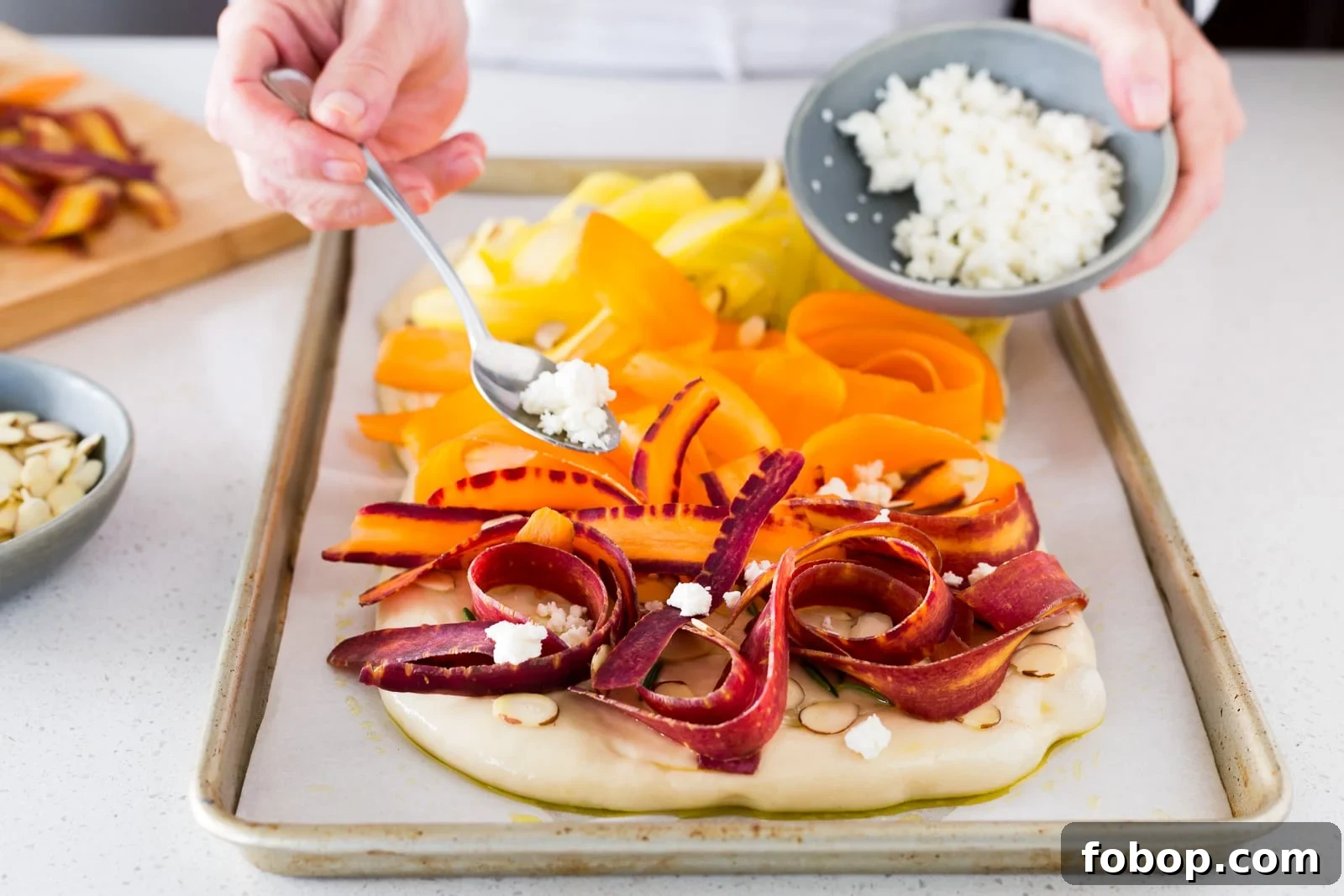 sprinkling-cheese-on-carrot-focaccia-before-baking