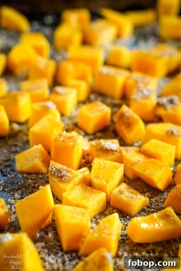 A close up of butternut squash that has been sprinkled with cinnamon, salt and brown sugar. 