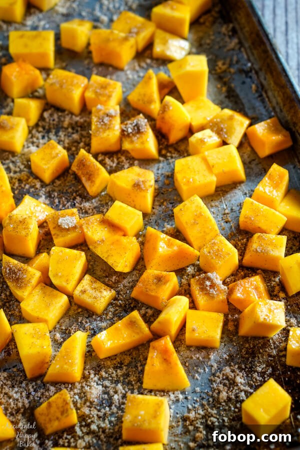 Bourbon-Cinnamon Roasted Butternut Squash Recipe 5 A baking sheet full of bourbon and cinnamon butternut squash ready to be placed in the oven.