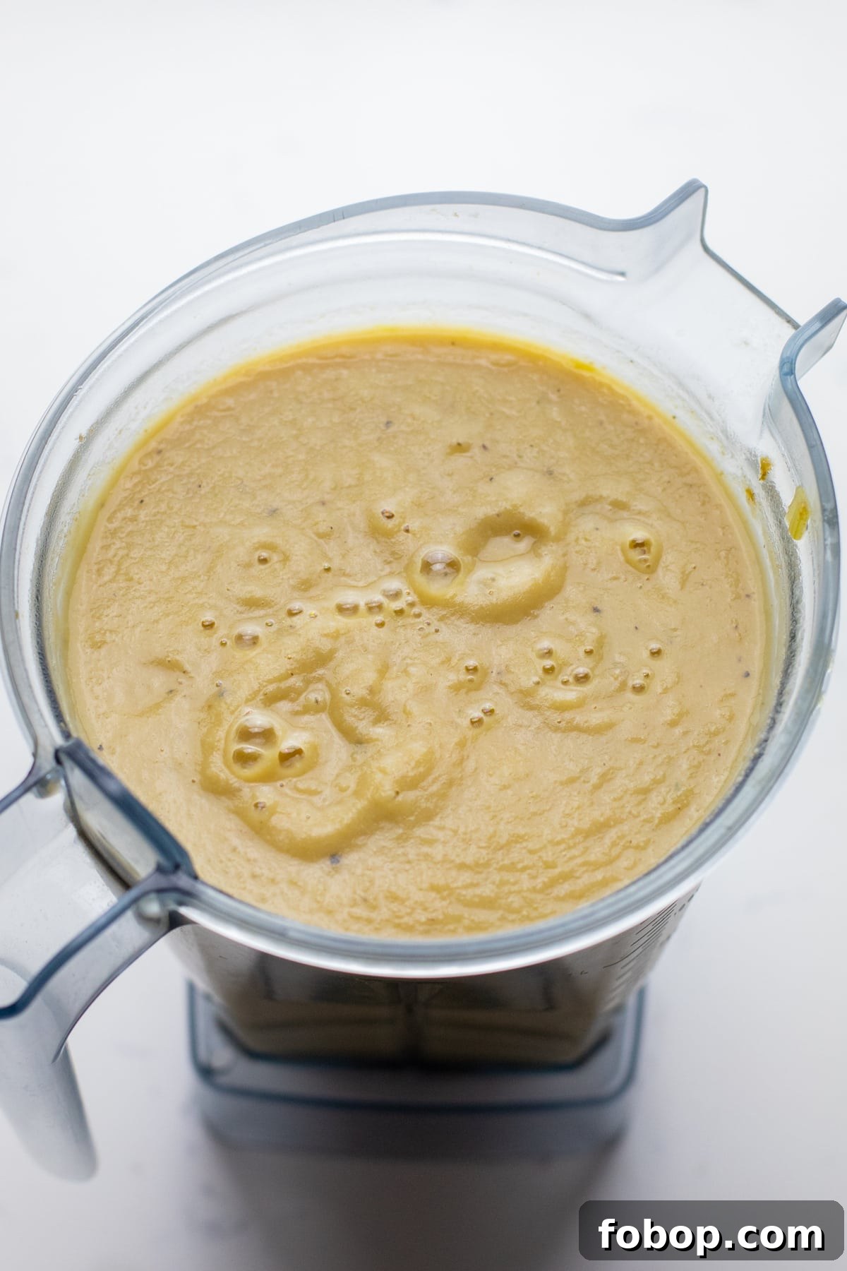 Creamy Vegan Cauliflower Soup Recipe — Dairy-Free Comfort Bowl 6 A vitamix blender with creamy cauliflower soup in it.