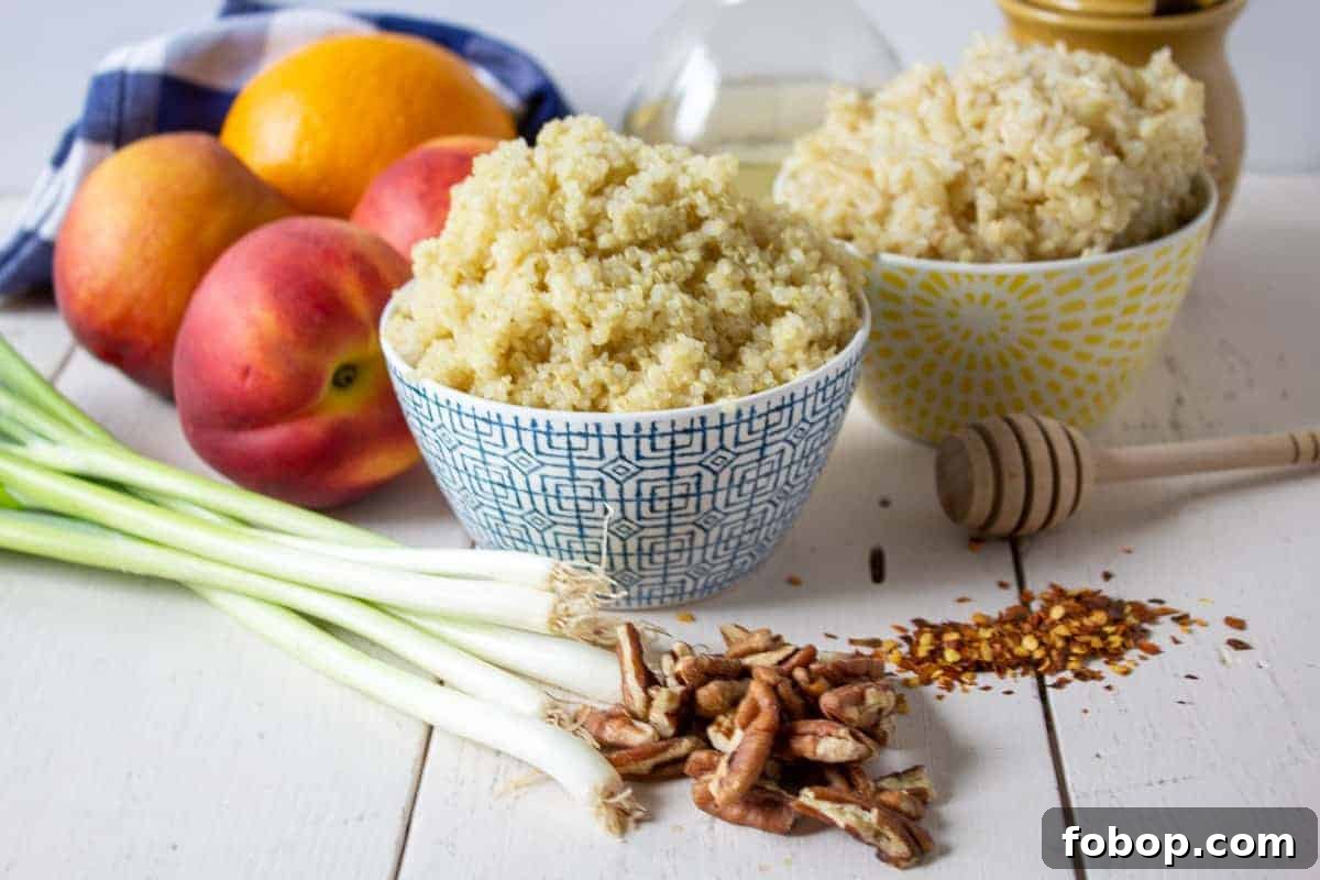 Bowls of quinoa and rice with fresh peaches and green onions next to the bowls. 