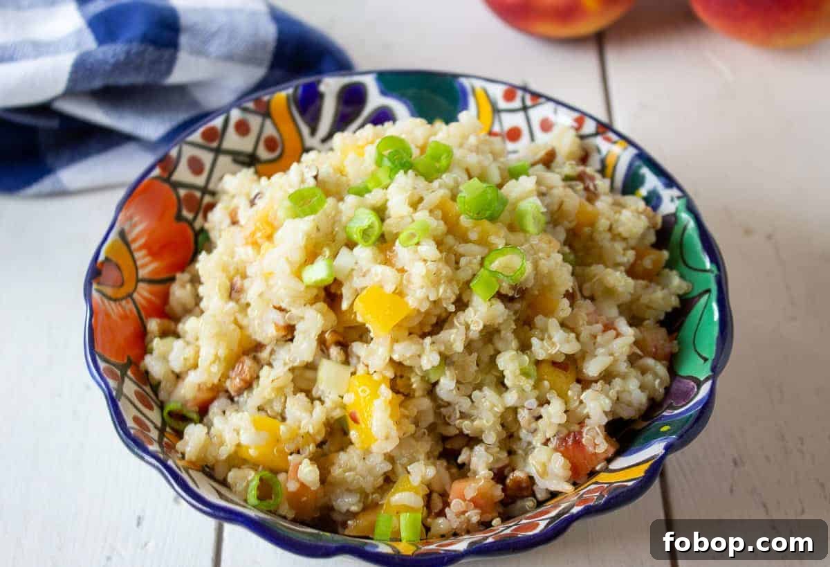 A colorful bowl filled with a quinoa and rice salad. 