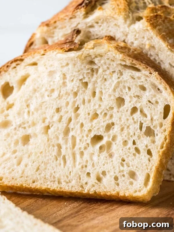 Sourdough bread loaf with a slice resting against it.