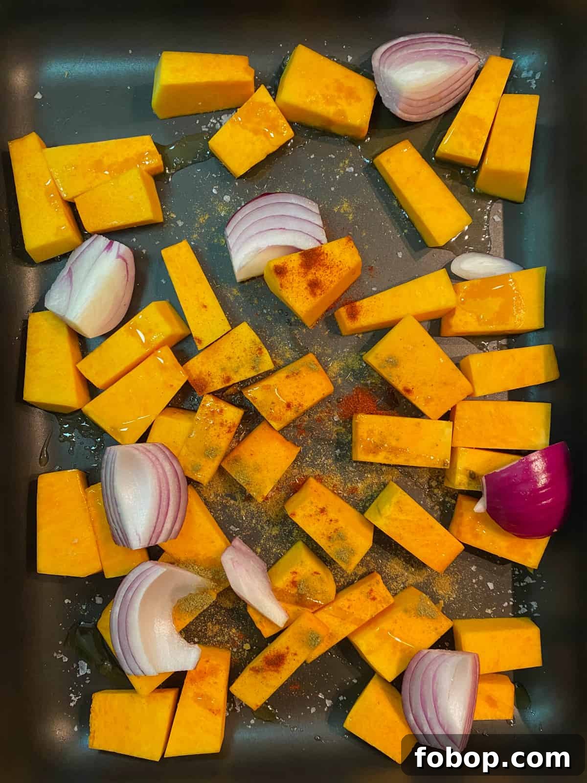 Spinach & Butternut Squash Salad with Smoky Mushroom Bacon and Vegan Feta 6 Photo of a roasting tray with squash, red onions and spices ready to go in the oven.