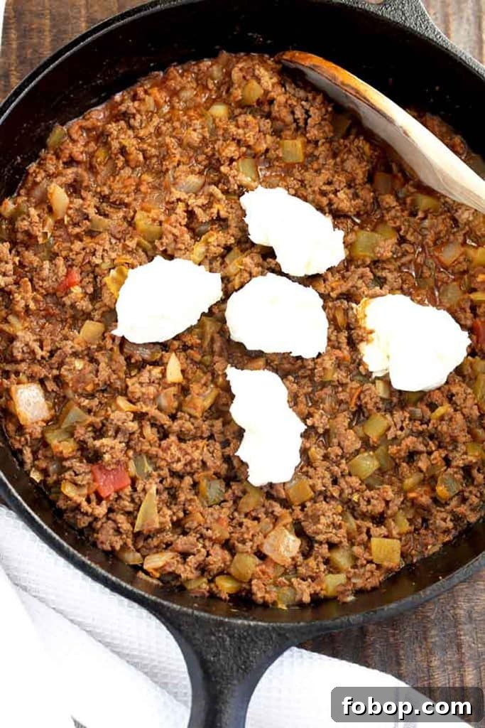 cream cheese pieces on top of the taco dip