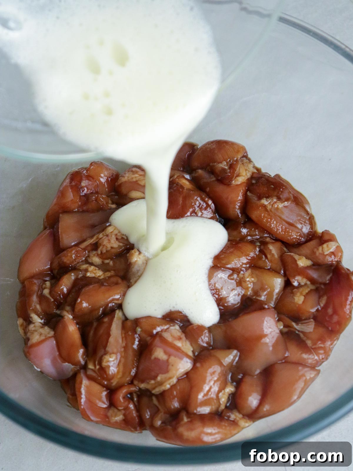 Calamansi Chicken Recipe: Tangy Citrus-Glazed Roast Chicken 4 pouring batter in a bowl of marinated chicken cubes