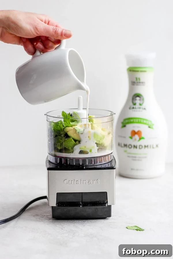 All of the sauce ingredients being added to a food processor.