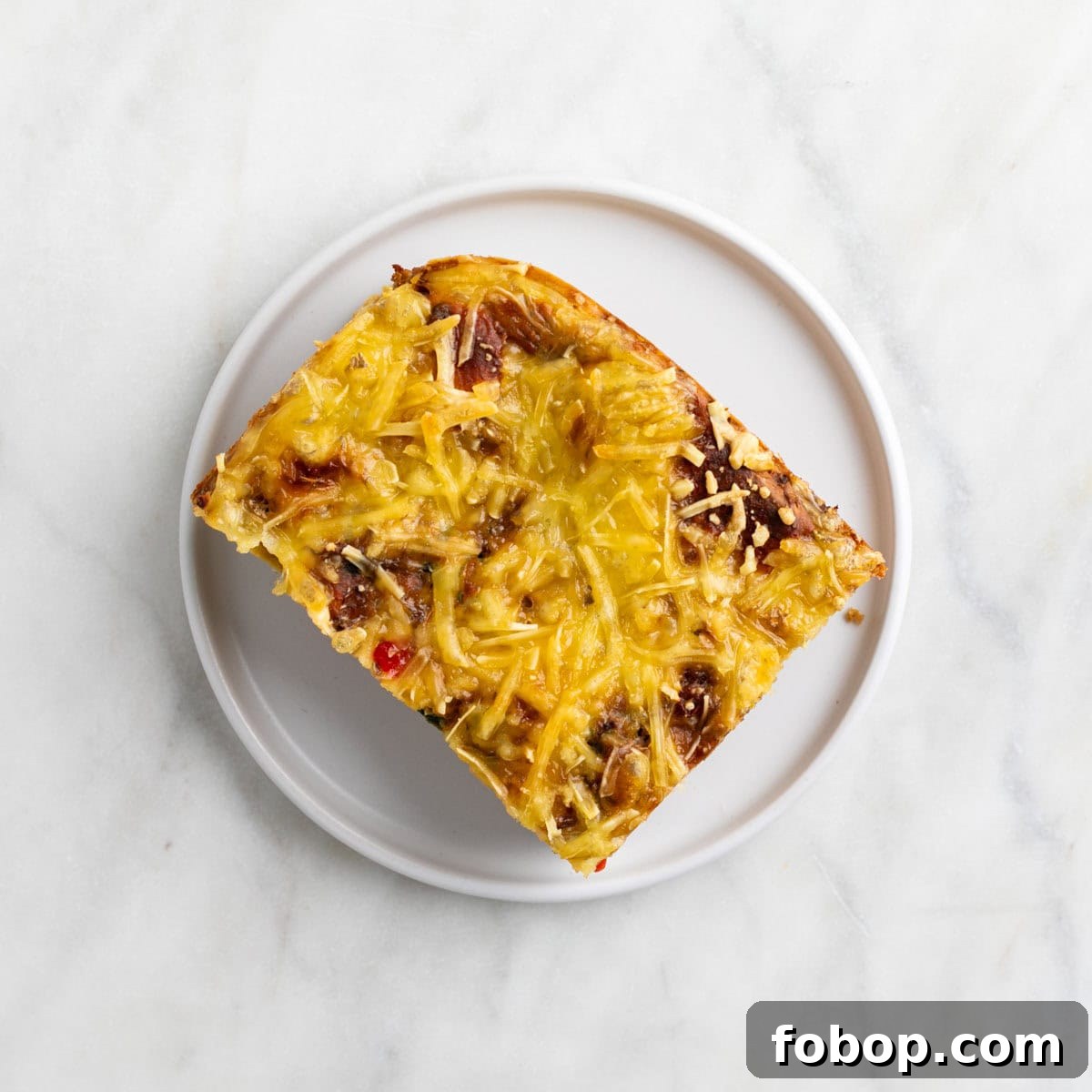 Slice of vegan breakfast casserole on a plate.