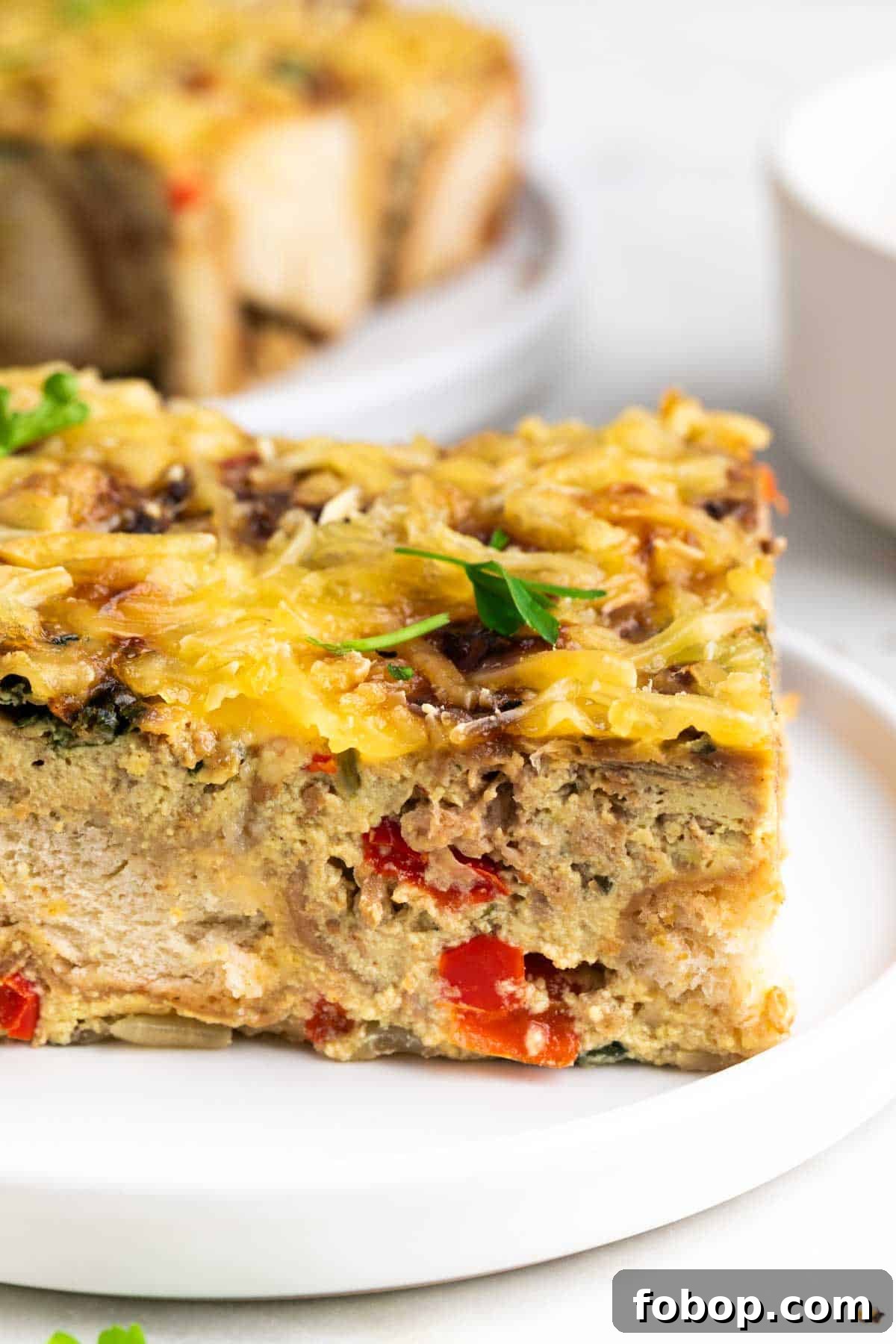 Plated vegan breakfast casserole with parsley garnish.