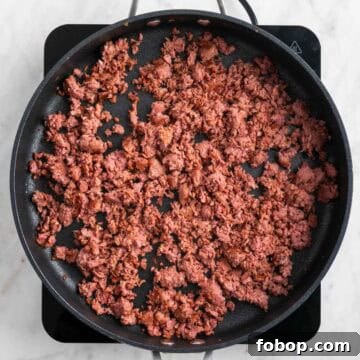 Cooked vegan sausage in a skillet.