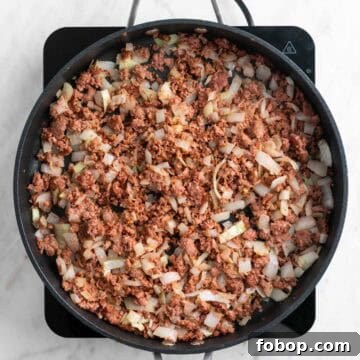 Cooked vegan sausage in a skillet.