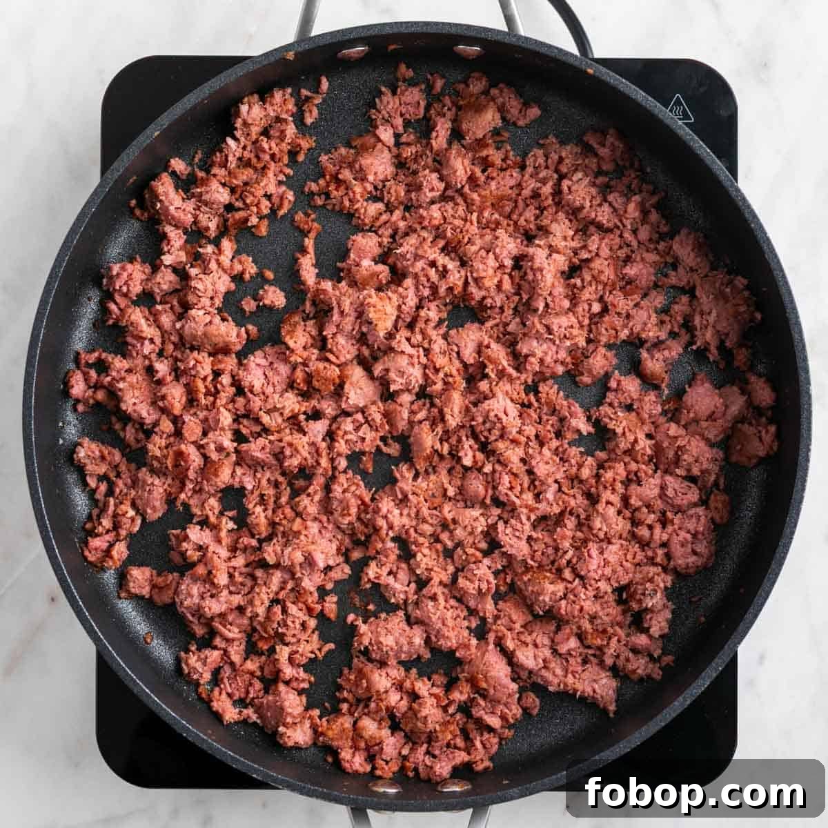 Cooked vegan sausage in a skillet.