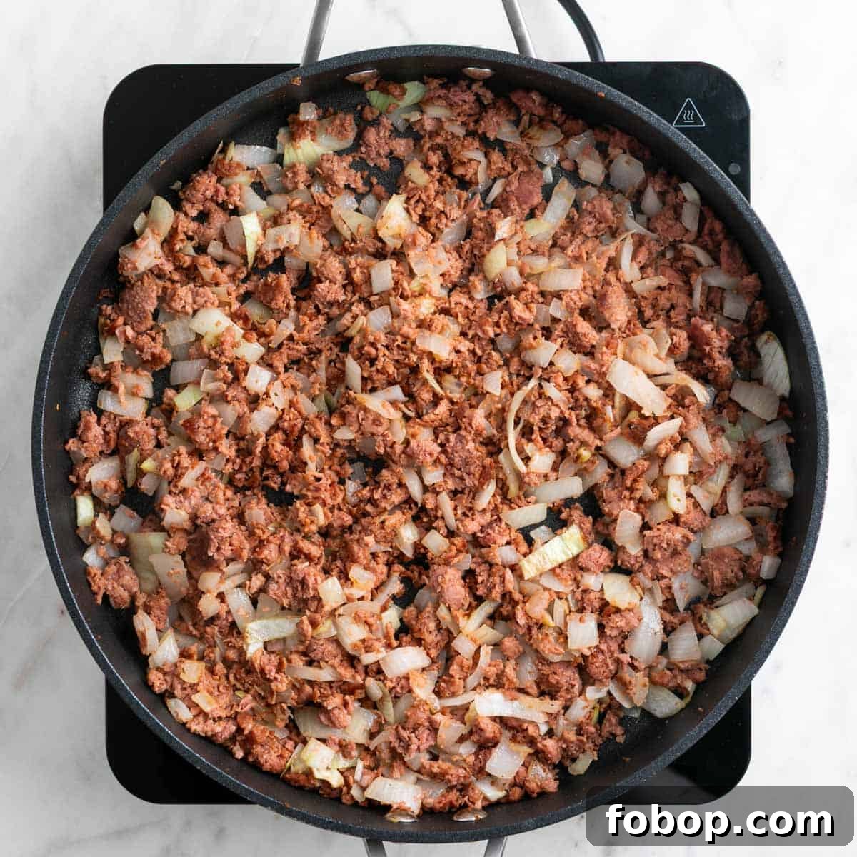 Cooked vegan sausage in a skillet.