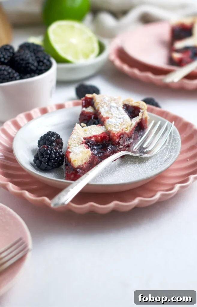 Blackberry Crostata Recipe: Rustic Tart with Fresh Berries 3 slice of crostata on a plate with a fork and blackberries